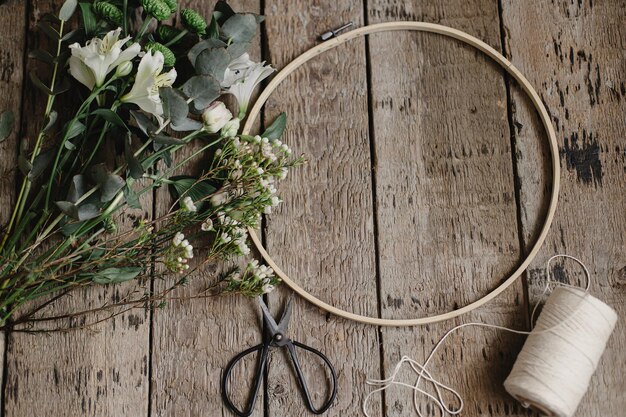 hoop with floral embroidery on wooden table